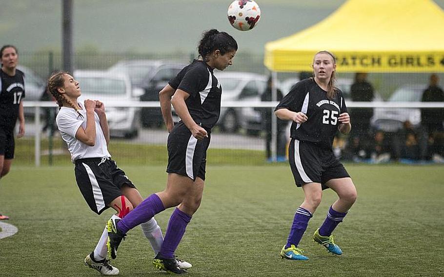 Bahrain's Asmaa Husseina, center, heads the ball away from AFNORTH's Kyla Kolosky as Helena Blaisdell-Black watches during the DODEA-Europe Division II semifinals in Reichenbach, Germany, on Friday, May 19, 2017. AFNORTH won the match 2-1 in double overtime. MICHAEL B. KELLER/STARS AND STRIPES