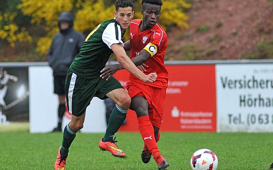 SHAPE's Alvaro Segura and Kaiserslautern's Alexander Dexter battle for the ball in a Division I semifinal at the DODEA-Europe soccer finals in Reichenbach, Germany. Kaiserslautern won 5-0 to advance to Saturday's finals.