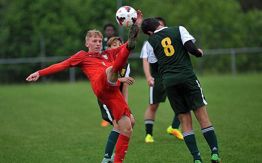 Kaiserslautern's Tyler Jankowski knocks the ball upfield against SHAPE's Roberto Liano in a Division I semifinal at the DODEA-Europe soccer finals in Reichenbach, Germany. Despite his acrobatics, Jankowski was called for a foul. Kaiserslautern won 5-0 to advance to Saturday's finals.
