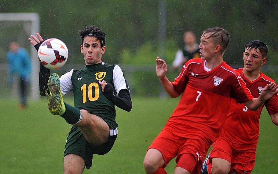SHAPE's Riccardo Pellegrino clears the ball in front of Kaiserslautern's Philipp Rimmler and Conner Mackie in a Division I semifinal at the DODEA-Europe soccer finals in Reichenbach, Germany. Kaiserslautern won 5-0 to advance to Saturday's finals.