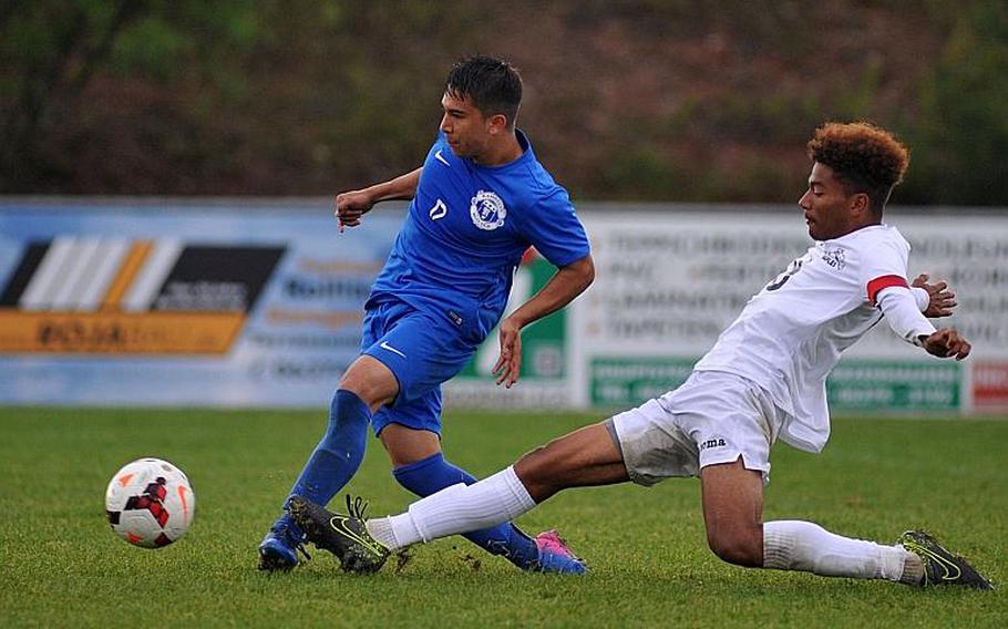 Ramstein's Dante Lapitan scores the winning goal in overtime against Naples as Nate Stewart tries in vain to stop him in a Division I semifinal at the DODEA-Europe soccer championships in Reichenbach, Germany. Ramstein advances to Saturday's final against crosstown rival Kaiserslautern.