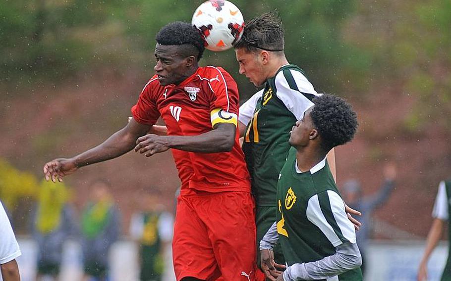Kaiserslautern's Alexander Dexter, left, and SHAPE's Cesare Vetrano try for a header in a Division I semifinal at the DODEA-Europe soccer finals in Reichenbach, Germany. Kaiserslautern won 5-0 to advance to Saturday's finals. At right is KalexRobledo.