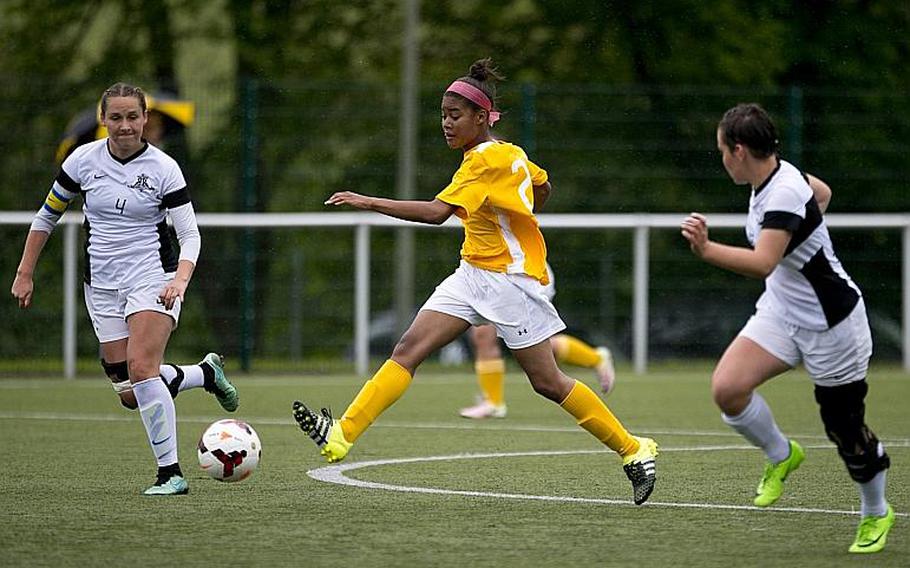 Stuttgart's Victoria Antoine passes the ball between Ramstein's Lakyn Parker, left, and Mackenzie Sauter during the DODEA-Europe Division I semifinals in Reichenbach, Germany, on Friday, May 19, 2017. Stuttgart won the match 4-0. MICHAEL B. KELLER/STARS AND STRIPES