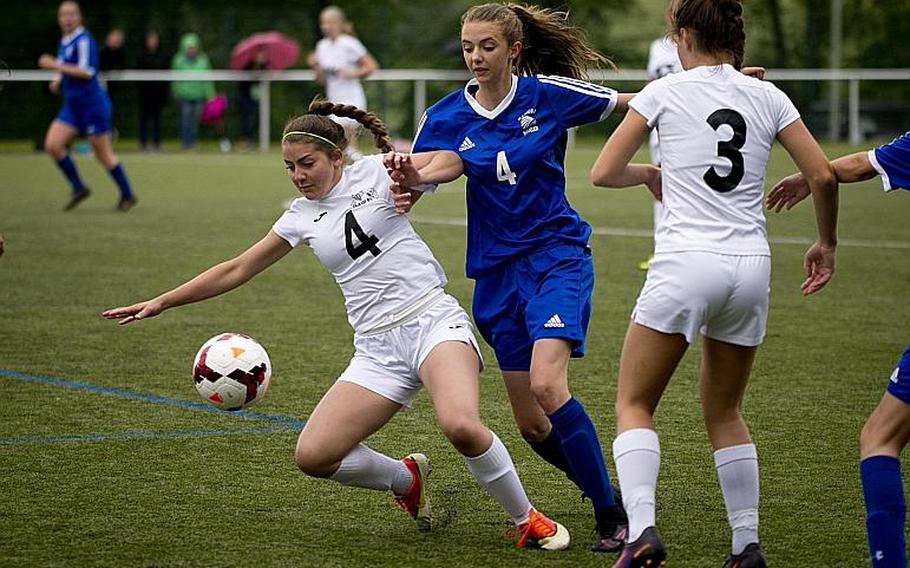 Wiesbaden's Lily Hogenson tries to get to the ball past Naples' Isabella Wolstenholme, left, and Cora Houseworth during the DODEA-Europe Division I semifinals in Reichenbach, Germany, on Friday, May 19, 2017. Wiesbaden won the match 3-1. MICHAEL B. KELLER/STARS AND STRIPES