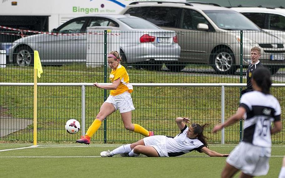Stuttgart's Lexington McLellan, left, takes a shot as Ramstein's Faith East tries to stop her during the DODEA-Europe Division I semifinals in Reichenbach, Germany, on Friday, May 19, 2017. Stuttgart won the match 4-0. MICHAEL B. KELLER/STARS AND STRIPES