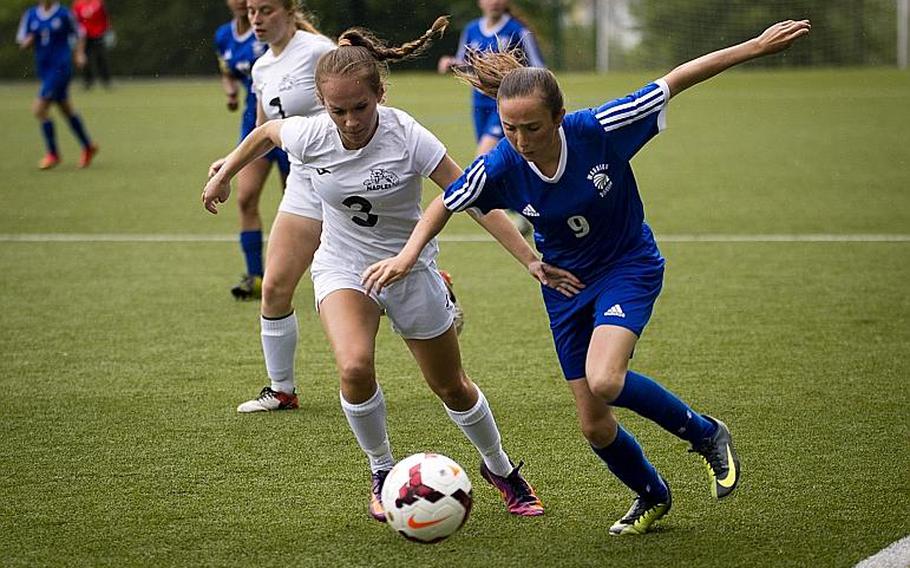 Wiesbaden's Erin Goodman, right, and Naples' Cora Houseworth race for the ball during the DODEA-Europe Division I semifinals in Reichenbach, Germany, on Friday, May 19, 2017. Wiesbaden won the match 3-1. MICHAEL B. KELLER/STARS AND STRIPES