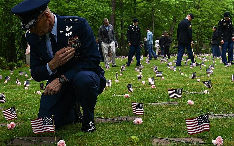 Maj. Gen. Timothy M. Zadalis, U.S. Air Forces in Europe and Air Forces Africa vice commander, pays his respects at the gravestone for Gary Currie, an infant who died in 1952, during the Ramstein Area Chief's Group and German-American and International Women's Club's Kindergraves Memorial Service in Kaiserslautern, Germany, May 20, 2017. 
