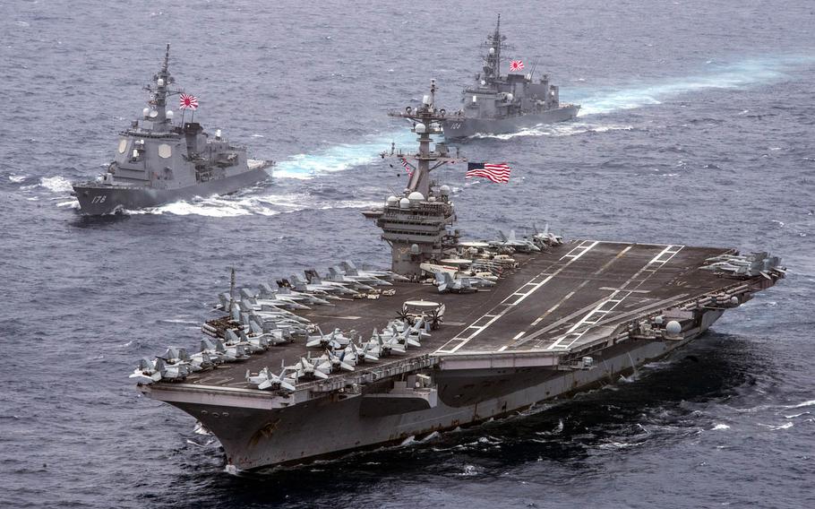 The aircraft carrier USS Carl Vinson, foreground, the Japan Maritime Self-Defense Force destroyers JS Ashigara, left, and the JS Samidare transit the Philippine Sea in April.