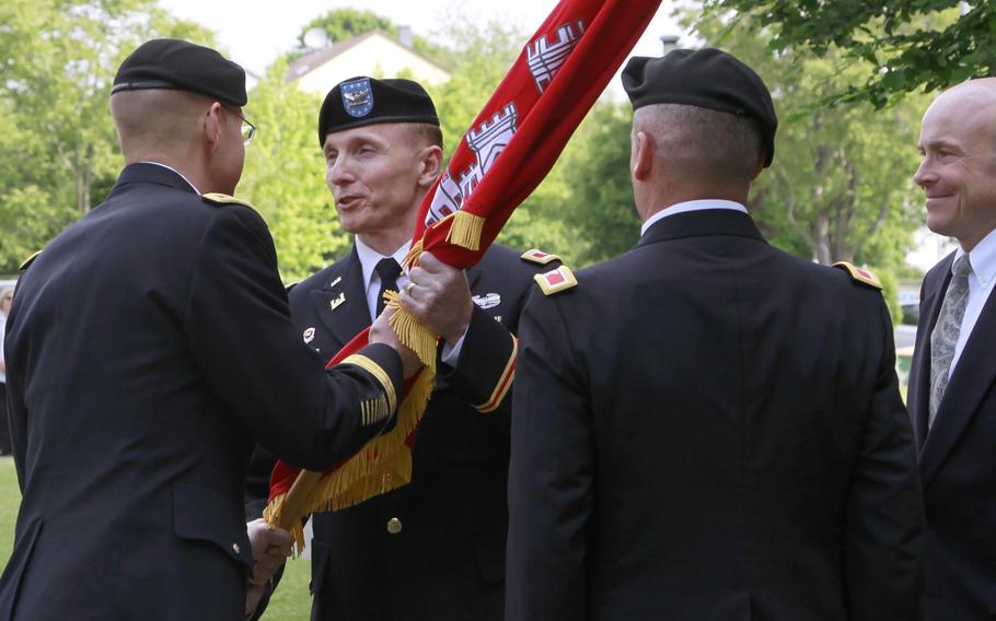 Col. John Baker, commander of Europe District, U.S. Army Corps of Engineers, accepts the colors from Brig. Gen. William Graham, commander of the North Atlantic Division, U.S. Army Corps of Engineers, during a change-of-command ceremony May 24 at the Amelia Earhart Center in Wiesbaden, Germany. 