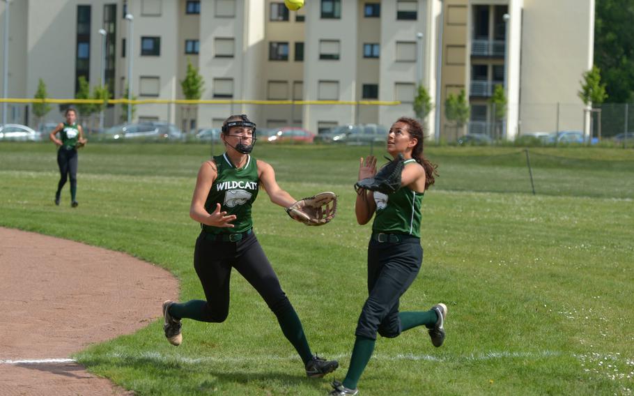 Naples' Sierra Dye, left, and Joy Jack chase a pop fly that Jacj caught in the Wildcats 10-6 loss to Wiesbaden in Division I action at the DODEA-Europe softball tournament in Kaiserslautern, Germany, Thursday, May 25, 2017.