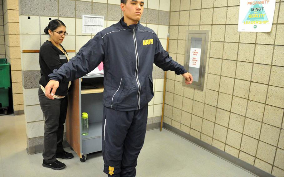A recruit tries on the Navy's new fitness suit at Recruit Training Command in Great Lakes, Ill., April 24, 2017.