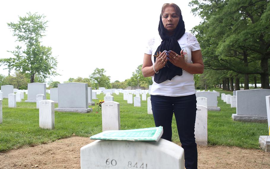 Gold Star Mother Sheba Khan prays at the grave of her son, Marine Cpl. Kareem Rashad Sultan Khan, 20, who was killed in Iraq on Aug. 6, 2007. She said that on the weekends that she cannot make it to Arlington, she ends up feeling like something is missing.