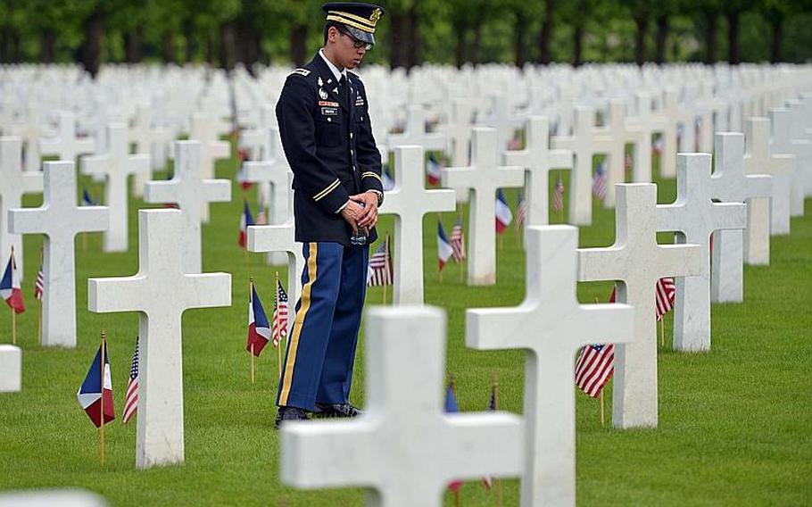 First Lt. Huy Nguyen of the 421st Medical Battalion out of Baumholder, Germany, reads the names on some of the graves following the Memorial Day ceremony at Meuse-Argonne American Cemetery in Romagne-sous-Montfaucon, France, Sunday, May 28, 2017. With 14,246 American World War I dead buried here, it is the largest American cemetery in Europe.