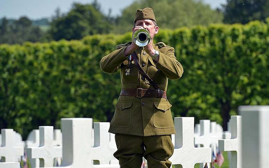 Dressed in a World War I-era uniform, Pascal Bouilleaux plays ''Taps'' at the end of the Memorial Day ceremony at Meuse-Argonne American Cemetery in Romagne-sous-Montfaucon, France, Sunday May 28, 2017.