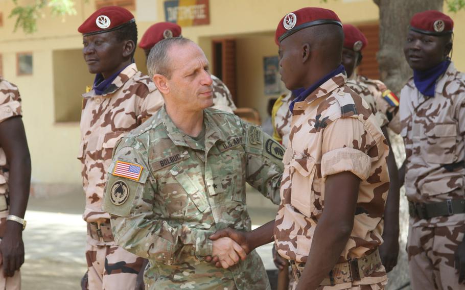 Brig. Gen. Donald Bolduc, commander, Special Operations Command Africa, greets Chadian personnel participating in the Flintlock 2017 closing ceremony on March 16, 2017, in N'Djamena, Chad. Bolduc said in an article published in the online Small Wars Journal that the lack of a U.S. government strategy hinders operations against extremists in Africa.