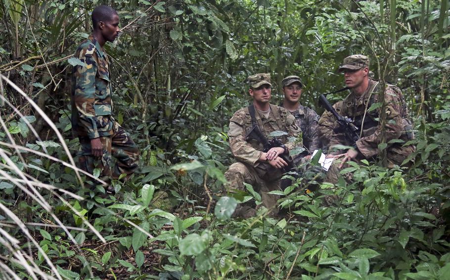 Ghana Armed Forces Sgt. Kofi Francis Donkor observes as U.S. soldiers assigned to the 1st Battalion, 506th Infantry Regiment, 1st Brigade Combat Team, 101st Airborne Division, navigate through the jungle during United Accord 2017 at the Jungle Warfare School at Achiase military base, Akim Oda, Ghana, May 26, 2017.