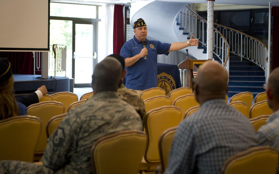 Lou Celli, American Legion National Veterans Affairs and Rehabilitation Division Director, speaks to audience members during a town hall meeting in Kaiserslautern, Germany, on Wednesday, May 31, 2017.