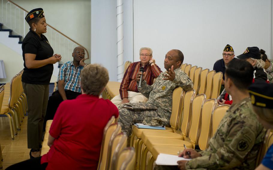 Verna Jones, American Legion Executive Director, left, listens to comments by U.S. Army Master Sgt. Tyler Brown during a town hall meeting in Kaiserslautern, Germany, on Wednesday, May 31, 2017.