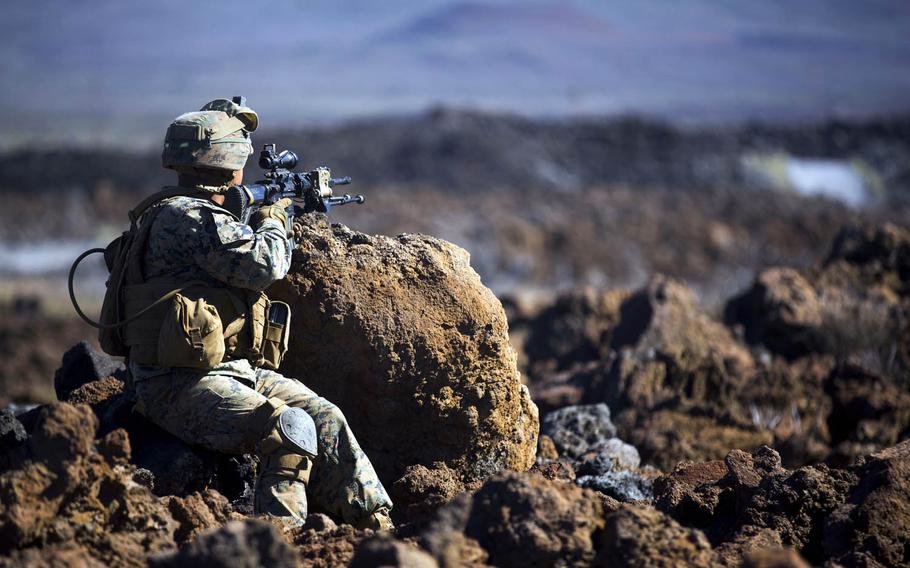 A Marine with Alpha Company, 1st Battalion 3rd Marine Regiment scans the horizon of Pohakuloa Training Area, Hawaii, during the Lava Viper exercise, an annual combined arms training drill that includes artillery and air support, Nov. 2, 2016.