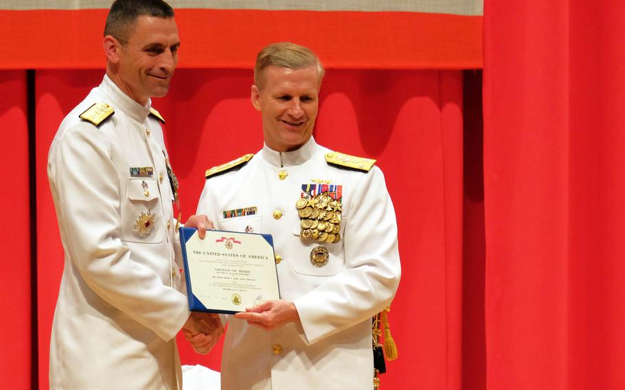 Outgoing Naval Forces Japan Commander Rear Adm. Matthew Carter, left, receives the Legion of Merit award from 7th Fleet Commander Vice. Adm. Joseph Aucoin during a change-of-command ceremony at Yokosuka Naval Base, Japan, Friday, June 16, 2017.