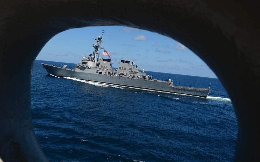 The destroyer USS Fitzgerald pulls alongside amphibious assault ship USS Bonhomme Richard as it transits the Pacific Ocean.