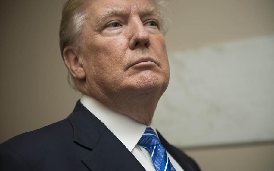 President Donald Trump waits to enter Arlington National Cemetery's Memorial Amphitheater in Arlington, Va., May 29, 2017.