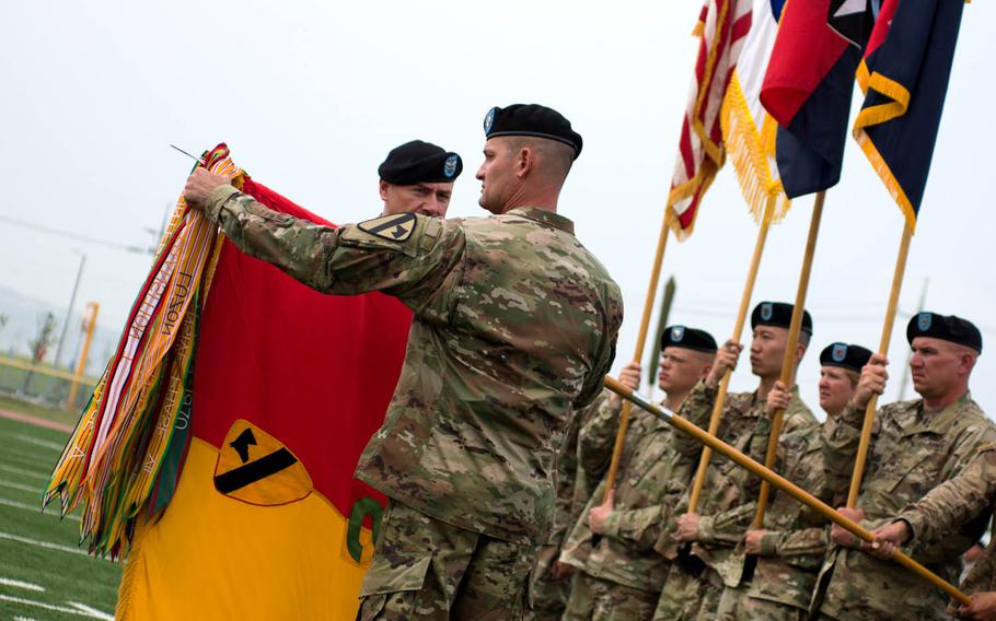 The 2nd Armored Brigade Combat Team, 1st Cavalry Division colors are uncased during a transfer-of-authority ceremony at Camp Humphreys, South Korea, Wednesday, June 28, 2017.