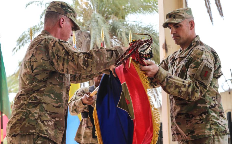 Maj. Gen. Joseph Martin, left, 1st Infantry Division commanding general, and Command Sgt. Maj. Joseph Cornelison case their division colors during the transfer-of-authority ceremony for the Combined Forces Land Component Command Operation Inherent Resolve in Baghdad, Iraq, on Wednesday, July 12, 2017.
