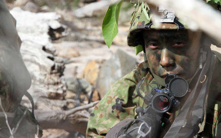 A Japan Ground Self-Defense Force paratrooper from the 1st Airborne Brigade, 3rd Battalion takes position during Talisman Saber drills at Shoalwater Bay Training Area, Australia, Friday, July 14, 2017.