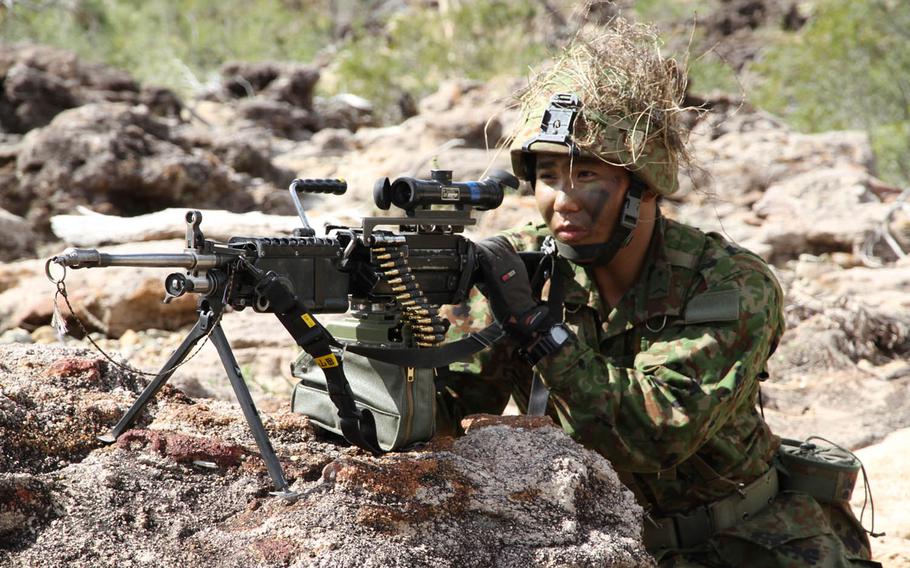 A Japan Ground Self-Defense Force paratrooper from the 1st Airborne Brigade, 3rd Battalion readies his machine gun during Talisman Saber drills at Shoalwater Bay Training Area, Australia, Friday, July 14, 2017.