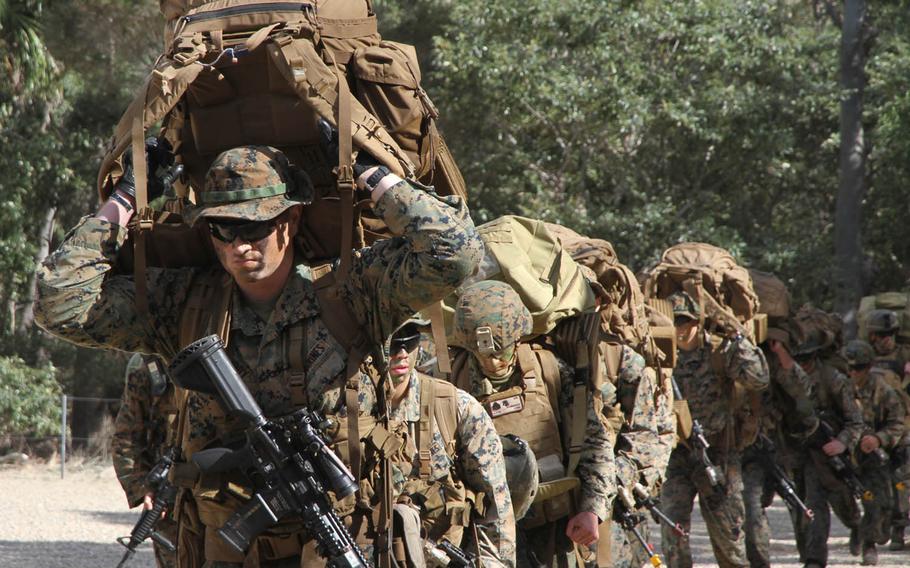 Marines from the 31st Marine Expeditionary Unit based in Okinawa, Japan, move inland after a successful joint U.S.-Australian amphibious assault drill that was part of exercise Talisman Saber in Queensland, Australia, Wednesday, July 19, 2017.