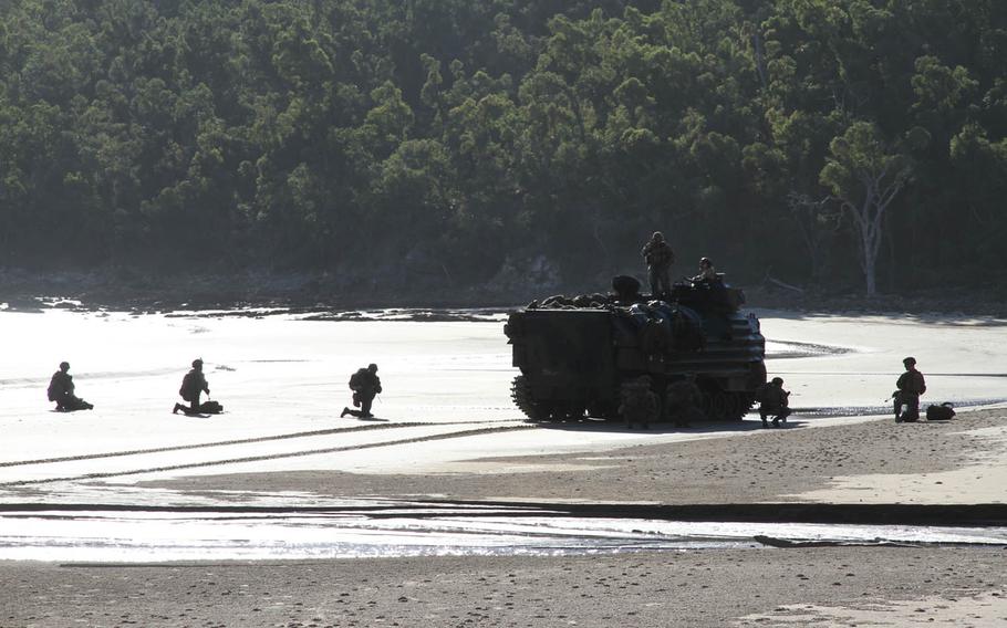 Marines set up security outside an amphibious assault vehicle during Talisman Saber drills at Freshwater Beach in Queensland, Australia, Wednesday, July 19, 2017.