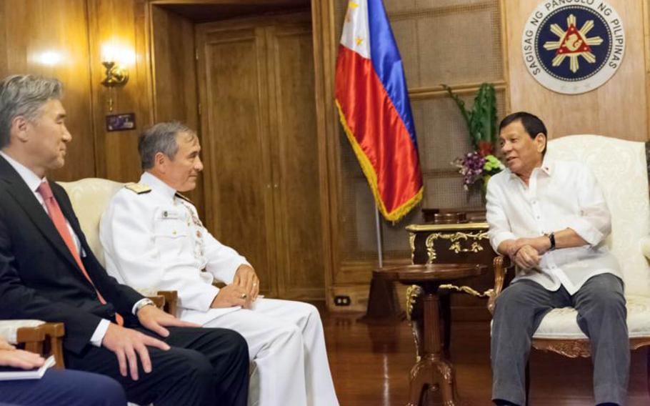 U.S. Ambassador to the Philippines Sung Kim, left, Commander of U.S. Pacific Command Adm. Harry Harris Jr., and Philippine President Rodrigo R. Duterte meet at Malacanan Palace in the Philippines, Wednesday, Aug. 23, 2017.