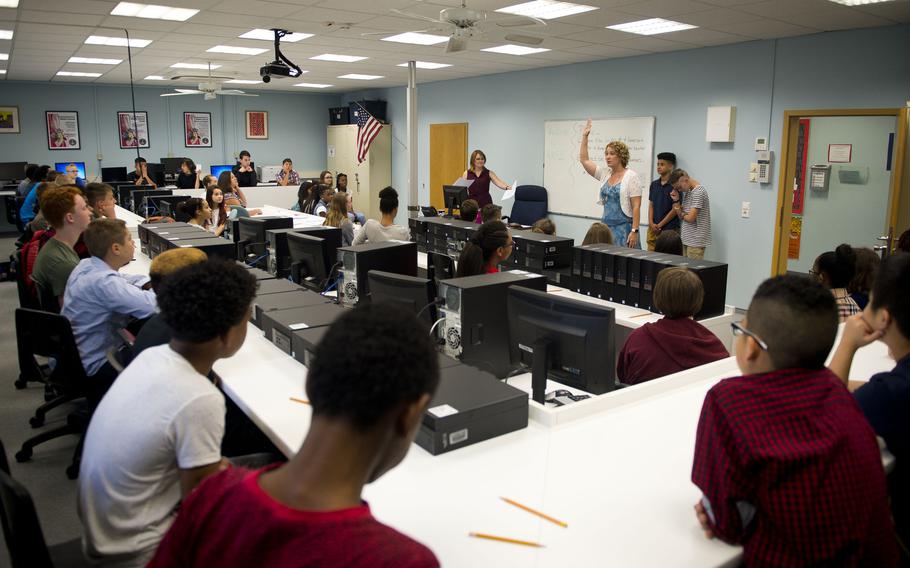 Seventh-grade students receive their schedules during the first day of school at Kaiserslautern Middle School at Vogelweh, Germany, on Monday, Aug. 28, 2017.