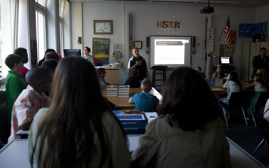 Kevin Morris, an education technologist at Kaiserslautern Middle School, speaks with students about proper internet usage during the first day of school at Vogelweh, Germany, on Monday, Aug. 28, 2017.