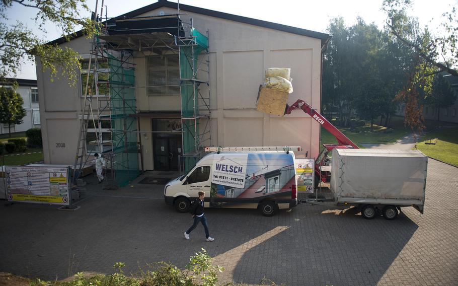 Workers remove debris from the second floor of Kaiserslautern High School at Vogelweh, Germany, on Monday, Aug. 28, 2017. The second floor of the school is closed while the roof is being repaired, after damage to a portion of the roof was discovered this summer during a routine inspection.