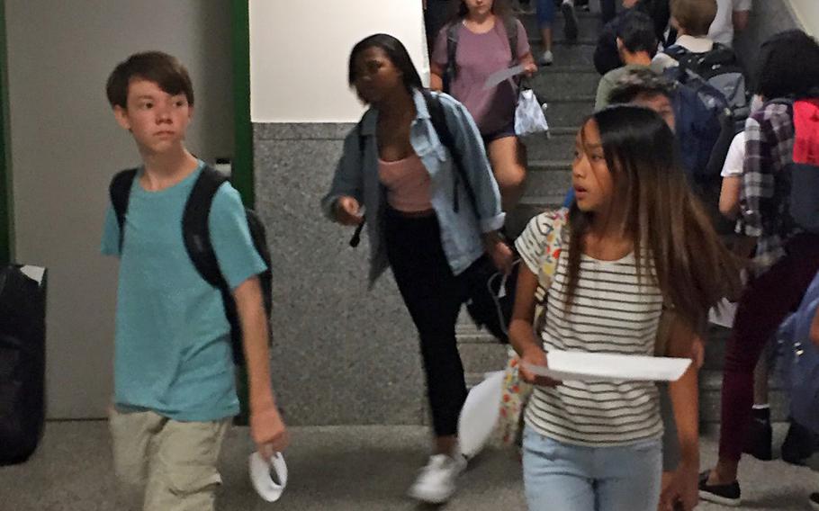 Students head to lunch or class during their first day back from summer break, Monday, Aug. 28, 2017, at Naples Middle High School near Naples, Italy.