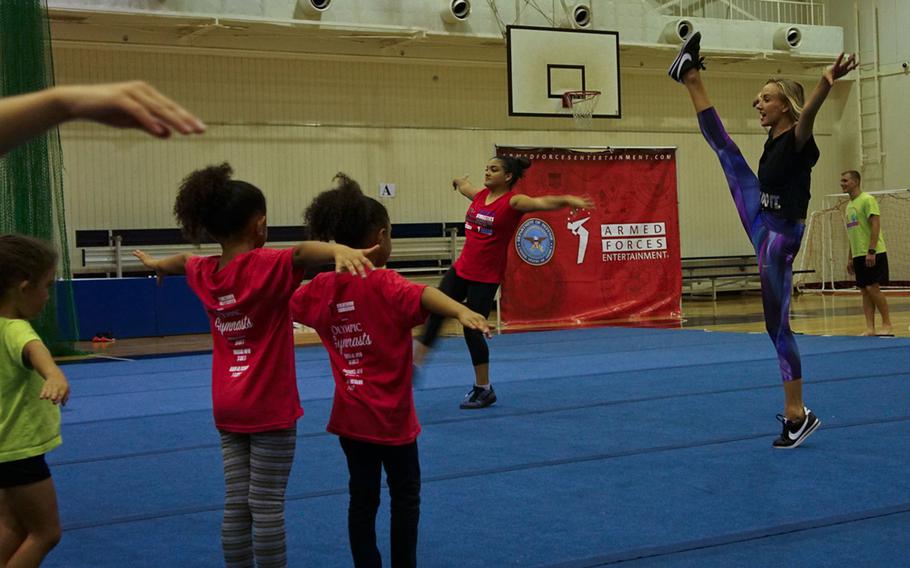 Nastia Liukin, all-around women's gymnastics champion and three-time silver medalist at the 2008 Summer Olympics, demonstrates a high kick during a youth gymnastics clinic at Yokota Air Base, Japan. Thursday, Aug. 30, 2017.