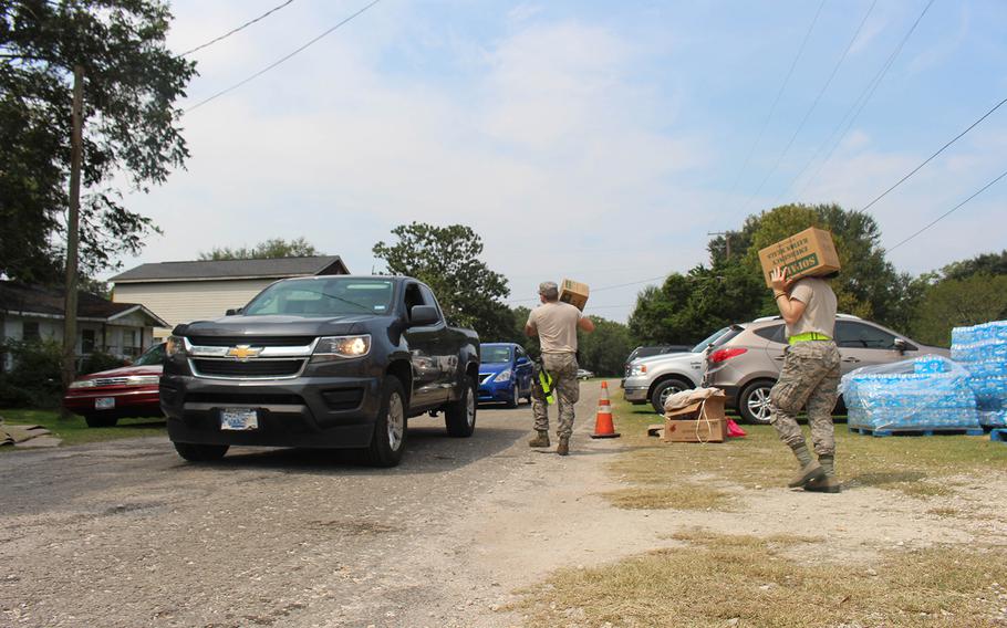 Members of the 136th Airlift Wing of the Texas National Guard provide emergency ration meals to residents of China, Texas, on Sept. 3, 2017.