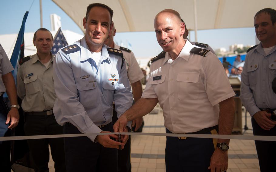 Col. Liran Cohen, head of the Israeli Defense Forces' air defense school, left, and Col. David Shank, commander of the US 10th Army Air & Missile Defense Command, cut the ribbon to open the first American military facility in Israel, at Mashabim Air Base, Monday, Sept. 18, 2017.