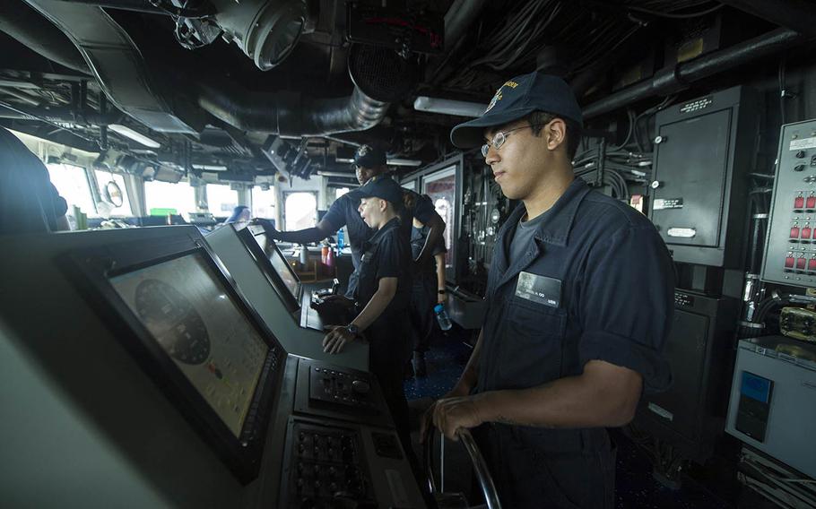 Seaman Daniel Oo stands watch aboard the USS Pearl Harbor on July 30, 2017.