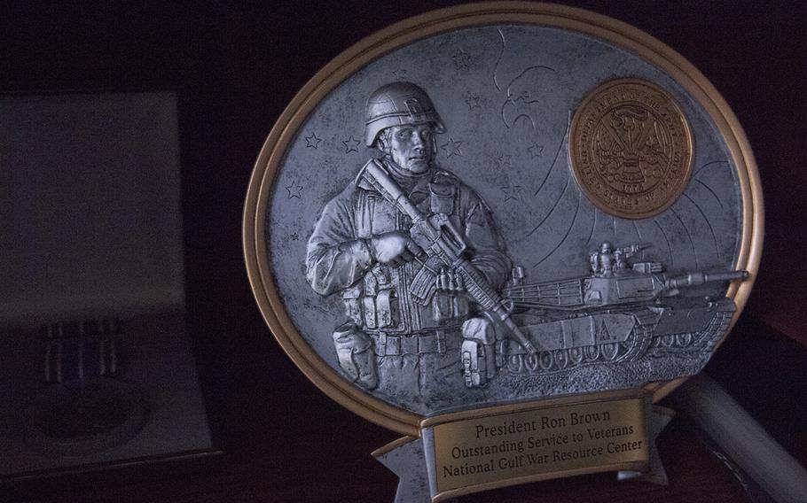 An award presented to Ronald Brown for his work with the National Gulf War Resource Center is displayed on a bookshelf in his home office in Roanoke, Va. NGWRC is a Topeka, Kansas-based nonprofit that helps veterans through the process of getting connected to VA benefits. Brown and Gulf War veterans Jim Bunker and Mike Jarrett volunteer with the organization.
