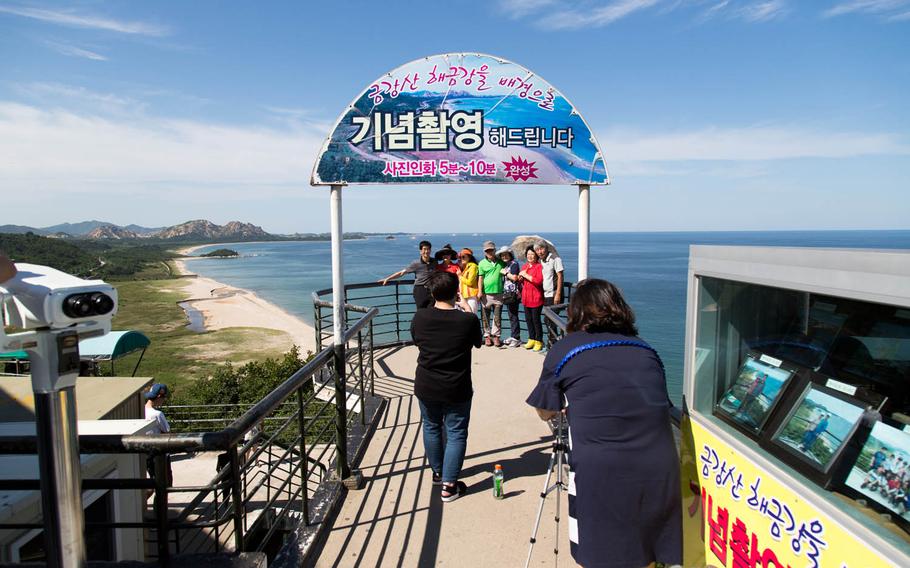 Tourists pose for a photo near the Demilitarized Zone in Goseong, South Korea, Saturday, Aug. 26, 2017.