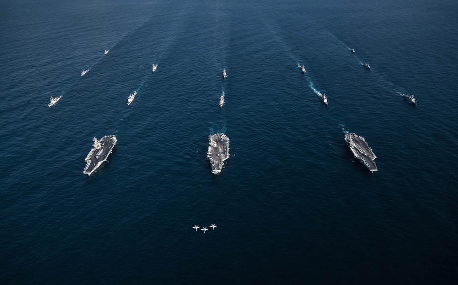 Three F/A-18E Super Hornets fly in formation over the aircraft carriers USS Ronald Reagan, USS Theodore Roosevelt, USS Nimitz and their strike groups, along with ships from the South Korean navy, east of the Korean Peninsula, Sunday, Nov. 12, 2017.