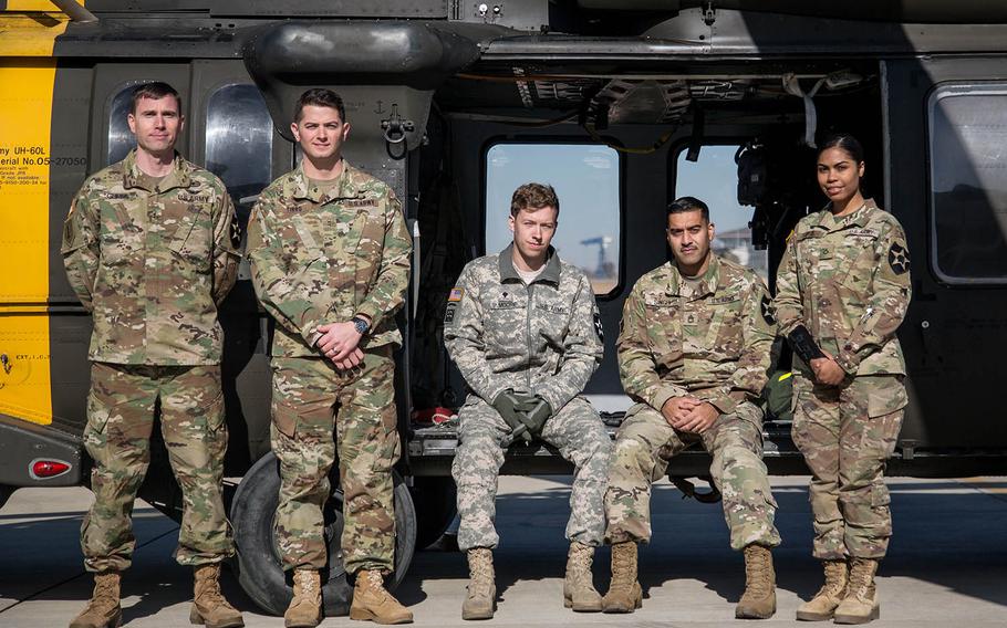 From left to right, Chief Warrant Officer 2 Nathan Gumm, pilot; Chief Warrant Officer 2 Eric Tirro, co-pilot; Spc. Carroll Moore, crew chief; Sgt. 1st Class Gopal Singh, flight medic; and Pfc. Karina Lopez, radio operator, pose at Camp Humphreys, South Korea, Thursday, Nov. 30, 2017.
