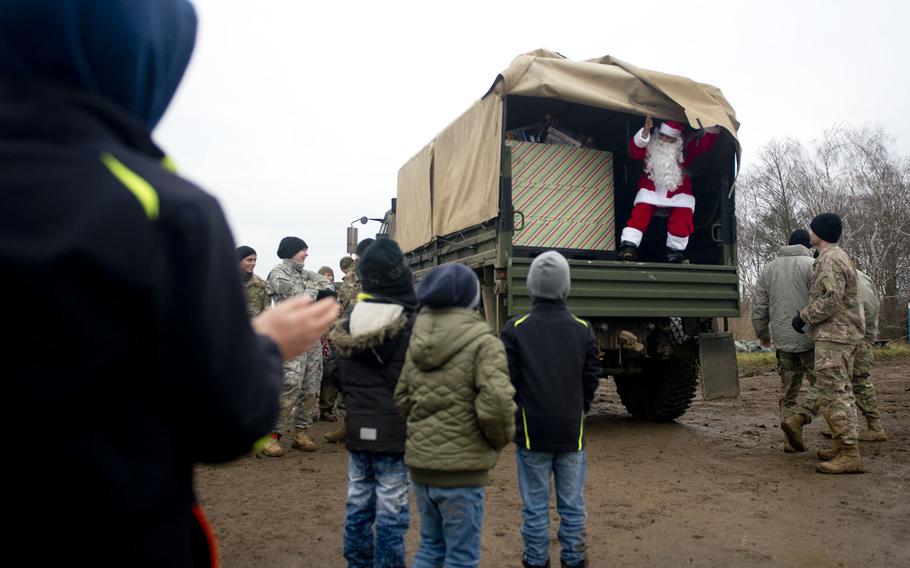Santa Claus reveals a box of toys near Alzey, Germany, on Wednesday, Dec. 6, 2017.