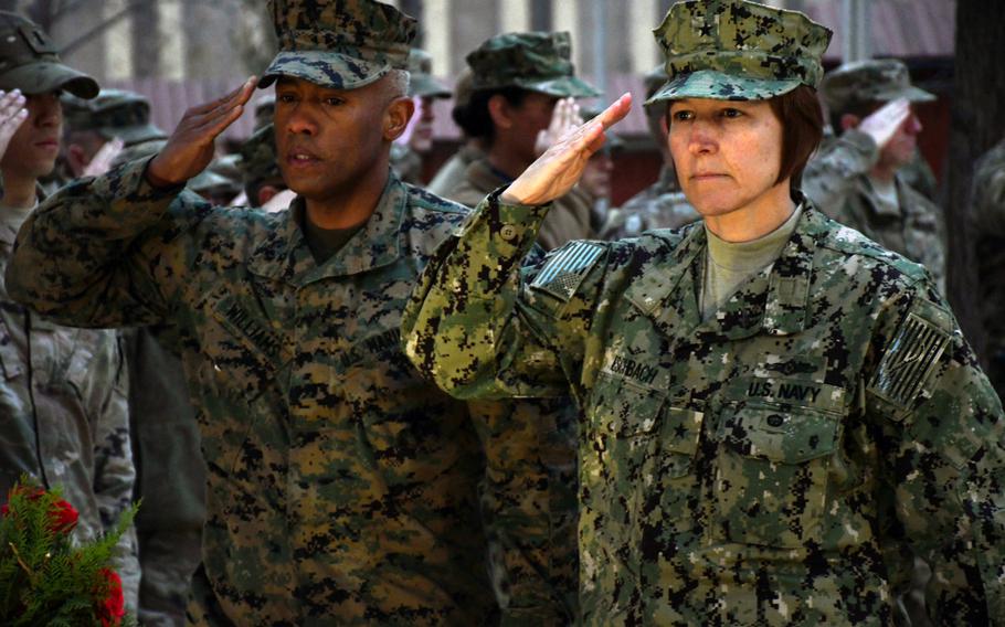 Navy Rear Adm. Kelly Aeschbach, right, and Marine Corps Brig. Gen. Terry Williams salute after laying a wreath at NATO's Resolute Support headquarters in Kabul on Thursday, Dec. 7, 2017, to mark the 76th anniversary of the attack on Pearl Harbor.