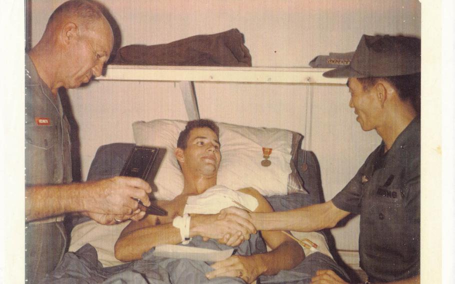 John Musgrave receives a Purple Heart while lying in a hospital bed in the surgical intensive care ward of Alpha Medical Battalion at a Marine base in Phu Bai, Vietnam on Nov. 10, 1967, after he was shot in the face by a North Vietnamese sniper. The 19-year-old infantry rifleman sustained life-threatening and permanently disabling injuries and overcame severe post-traumatic stress and now helps to counsel post-911 veterans. Photo courtesy of John Musgrave