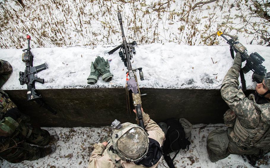 Soldiers from 1st Battalion, 5th Cavalry Regiment take up fighting positions at Camp Stanley, South Korea, Friday, Dec. 15, 2017.