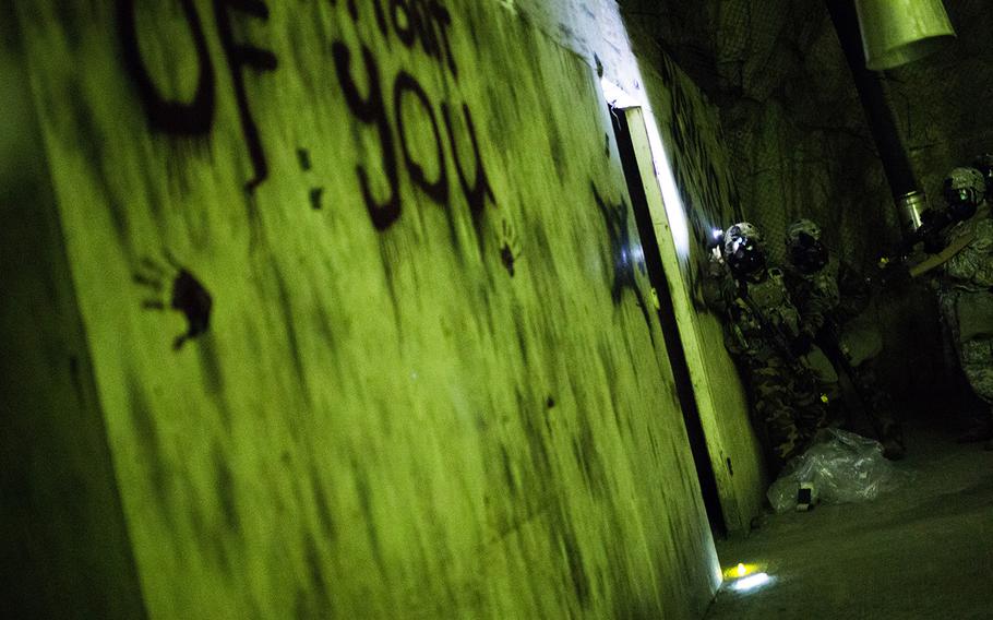 Soldiers from 1st Battalion, 5th Cavalry Regiment enter a suspected chemical weapons lab during a drill at Camp Stanley, South Korea, Friday, Dec. 15, 2017.